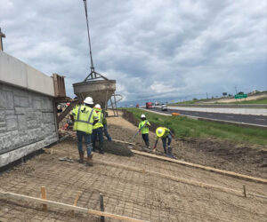 Crew pouring the concrete Rip rap slab for the HWY 185/59 turn round bridge section.
