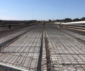 Crew tying steel getting ready for bridge deck machine to pour and form the concrete bridge deck on Loop 463 bridge near River Rd.